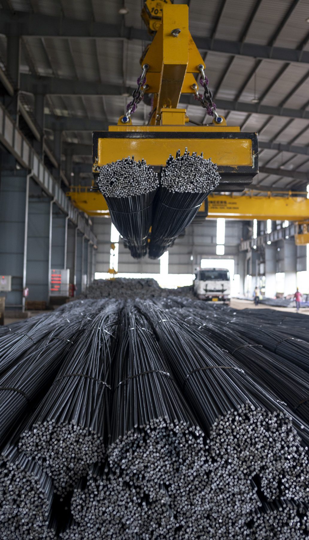 Bundles of finished TMT bars lifted by a magnet crane